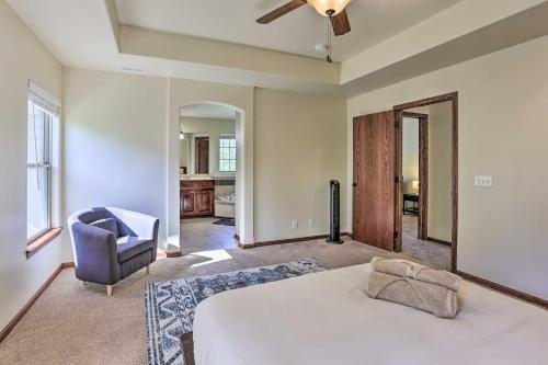 a bedroom with a bed and a chair in it at Spacious Omaha Home with Expansive Yard and Patio in Omaha
