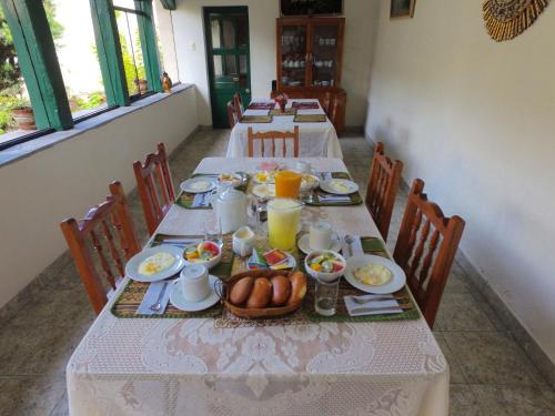 a table with plates of food and eggs on it at Hospedaje La Florida in Urubamba