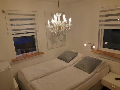 a living room with a bed and a chandelier at Country Dream - Langholt 2 in Selfoss