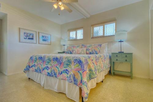 a bedroom with a bed with a colorful bedspread at Sugar Sands B in St Pete Beach