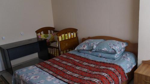 a small bedroom with a bed and a desk at RAHAT Guest House & Hostel in Toktogul in Toktogul