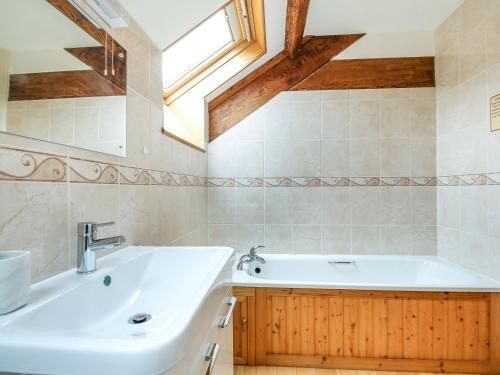 a bathroom with a sink and a bath tub at Y Bwthyn in Llanegryn