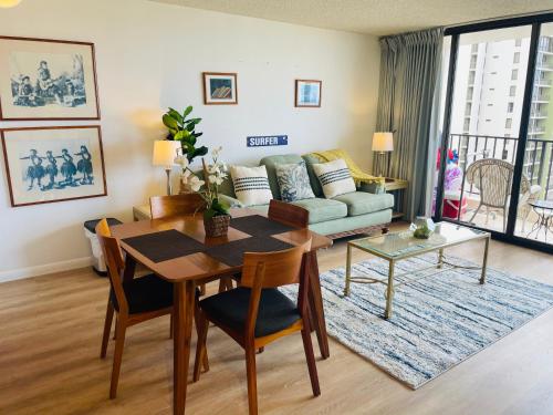 a living room with a table and a couch at Waikiki Banyan 3411 Ocean View - FREE PARKING in Honolulu