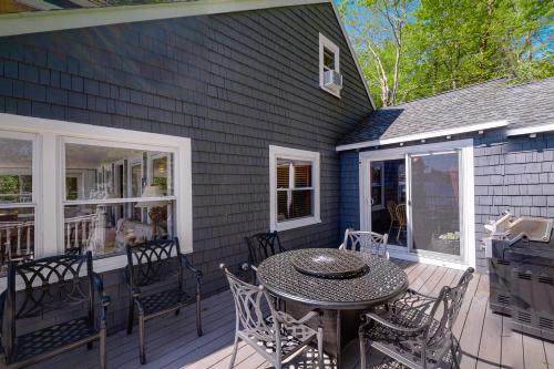 a patio with a table and chairs on a house at Highland Playhouse in Windham