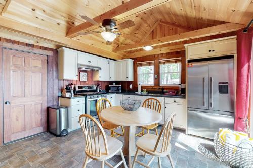 a kitchen with a table and chairs in it at Highland Playhouse in Windham