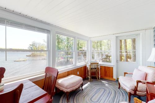 a room with windows and a table and chairs at Highland Playhouse in Windham