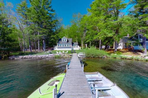 a boat is docked at a dock in front of a house at Highland Playhouse in Windham
