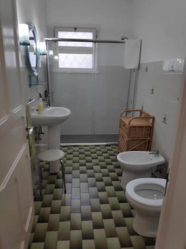 a bathroom with two toilets and a sink at House of Roses in Ponta Delgada
