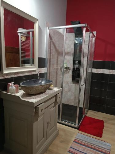 a bathroom with a sink and a shower at Oikos Dafne in Gravedona