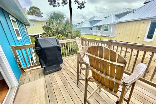 a deck with two chairs and a television on it at Shore Bird in Port Saint Joe