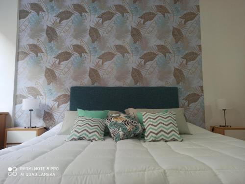 a white bed with pillows on it in a bedroom at Recoleta Beatiful Gran Callao Concord in Buenos Aires
