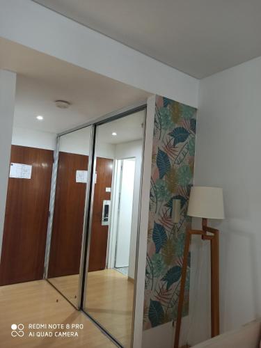 a room with a glass door and a mirror at Recoleta Beatiful Gran Callao Concord in Buenos Aires