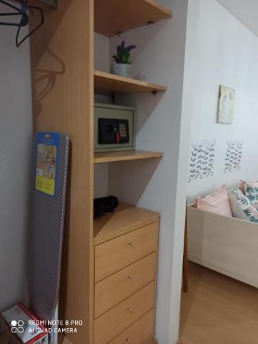 a room with a closet with a dresser and a microwave at Recoleta Beatiful Gran Callao Concord in Buenos Aires