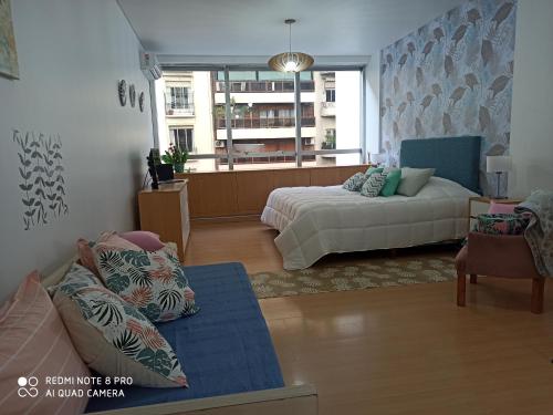 a living room with a bed and a couch at Recoleta Beatiful Gran Callao Concord in Buenos Aires