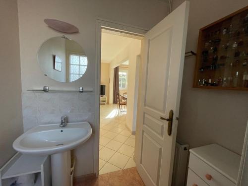 a bathroom with a sink and a mirror at Villa 5 pièces avec jardin, à 400m de la plage et 600m des commerces, wifi et barbecue inclus - FR-1-361-20 in Jullouville-les-Pins