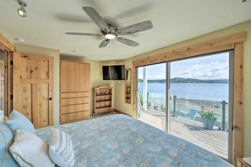 a bedroom with a bed and a view of the water at Similk Bay Retreat with Deck, Fire Pit and Hot Tub! in Anacortes