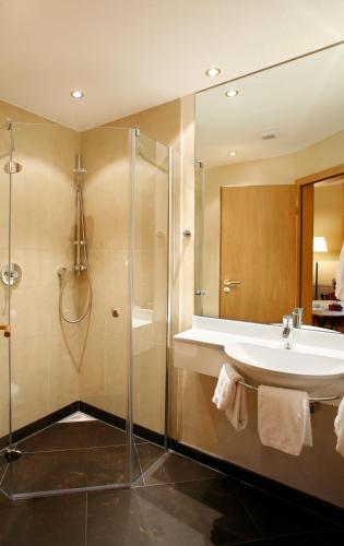 a bathroom with a sink and a shower at Flux-Biohotel Werratal in Hannoversch Münden