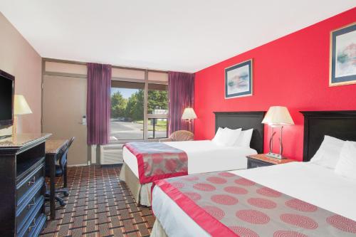 Säng eller sängar i ett rum på Ramada by Wyndham Edgewood Hotel & Conference Center
