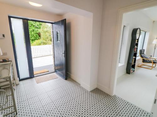 a hallway with a door leading to a patio at Wee Andy's in Buncrana