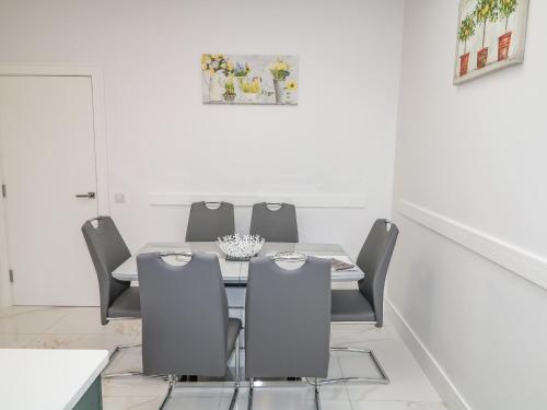 a dining room with a table and chairs at Wee Andy's in Buncrana