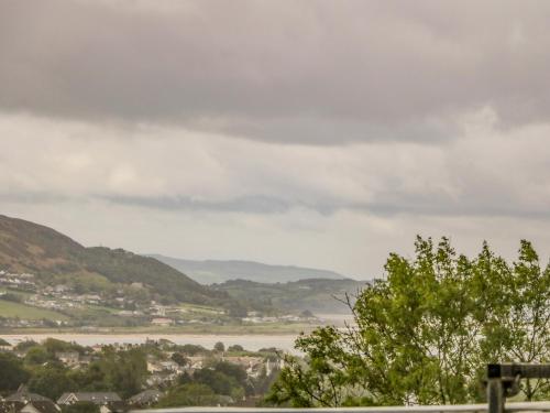 a view of a river with a town and hills at Wee Andy's in Buncrana