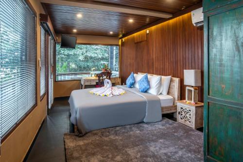 a bedroom with a bed and a tv in a room at PNB Beach Resort in Canggu