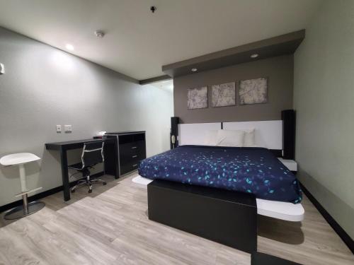 a bedroom with a bed and a desk in it at Crystal Inn in Porter
