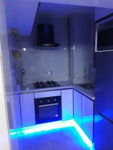 a kitchen with blue lights in a kitchen at Professionals Friendly with Work Station PS5 & near Beaches in Lekki