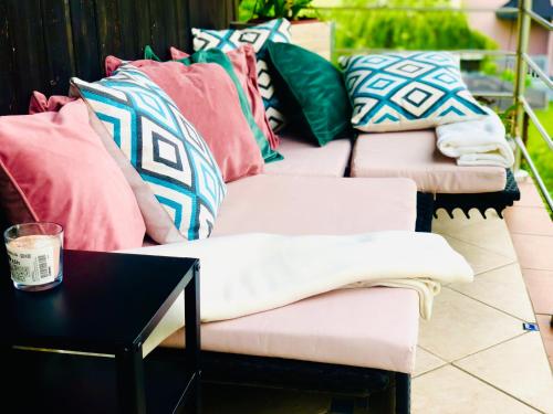 a group of pillows on a patio with a table at Garden House in Kranj