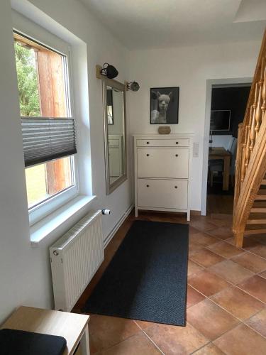 a living room with a dresser and a window at stylisches Ferienhäuschen in Güstrow