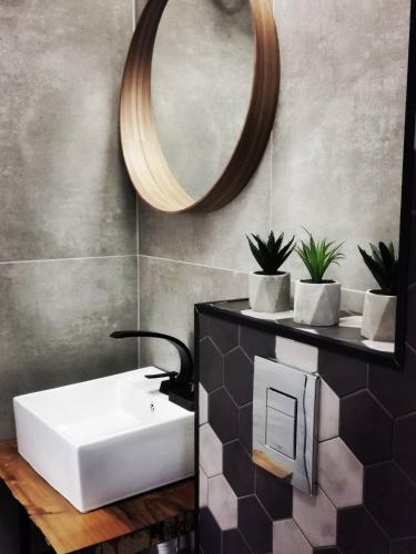 a bathroom with a white sink and a mirror at Blue Breeze in Sinemorets