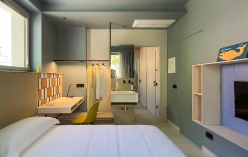 a bedroom with a large bed and a bathroom at Le stanze di Caterina in Cesenatico
