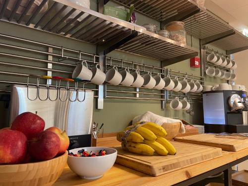 a kitchen counter with a bowl of fruit and utensils at Hemmet B&B in Simrishamn