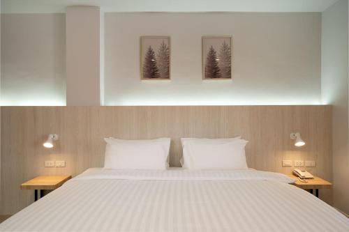 A bed or beds in a room at The Pride Hotel Phitsanulok