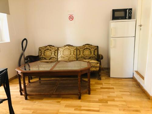 a living room with a couch and a refrigerator at A1 Stay Apartments in Copenhagen
