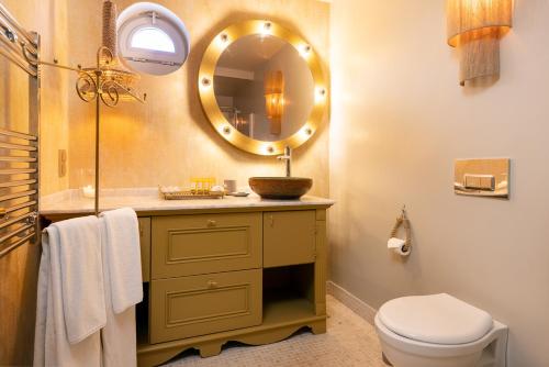 a bathroom with a sink and a mirror at La Capria Suite Hotel Alacati in Alacati