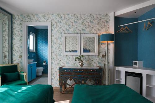 a blue bedroom with a bed and a fireplace at La Capria Suite Hotel Alacati in Alacati