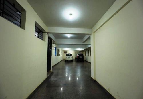 an empty hallway with a car parked in a building at Silver Suite in Chikmagalūr