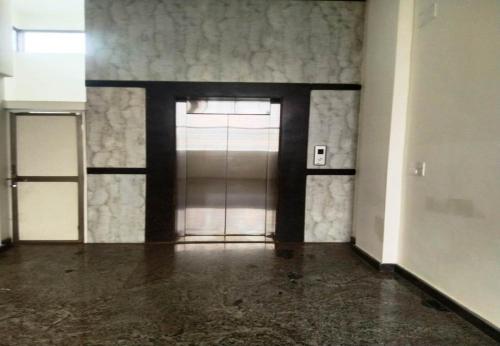 an empty room with a door in a building at Silver Suite in Chikmagalūr
