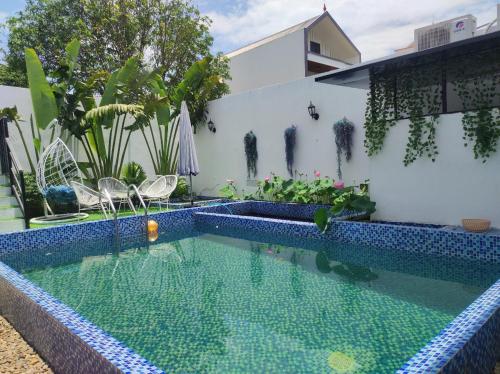 a swimming pool in front of a house at Balaha in Dong Hoi