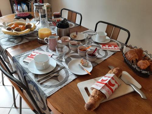a table with a breakfast of food on it at Au Chat Perché chambre double in Mareil-sur-Mauldre