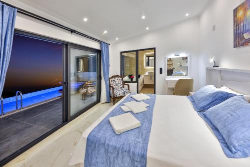 a bedroom with a bed and a large window at Villa Summery in Kalkan