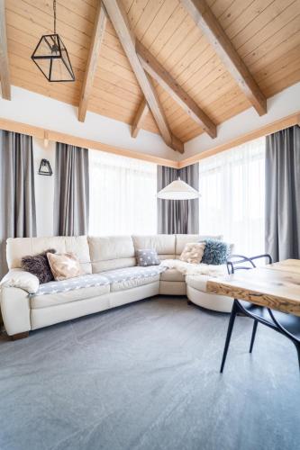 a living room with a white couch and a table at Farma František in Stachy