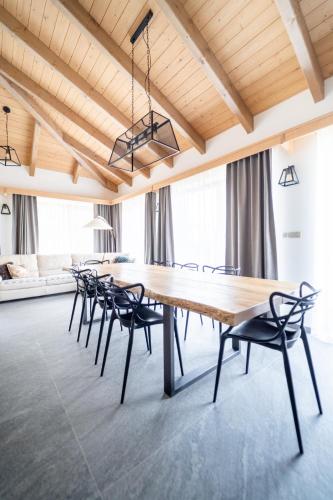a dining room with a large wooden table and chairs at Farma František in Stachy