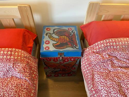 a bag sitting between two beds in a room at Ollediek in Houwerzijl