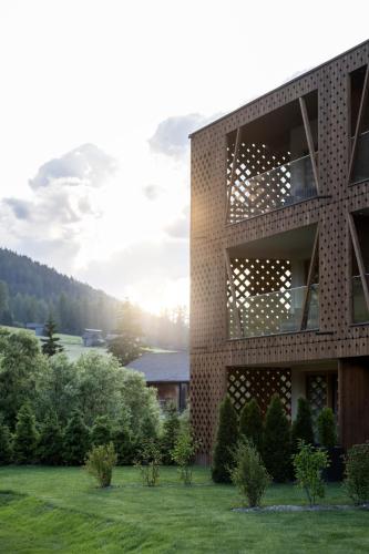 a brick building with a view of a field at Aparthotel Gamz in Sesto