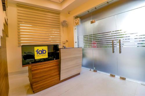 a room with a tv and a sliding door at FabHotel Prime K9 Regency in Jalandhar