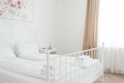 a white bedroom with a white bed and a sink at Spring Rustik in Čačak