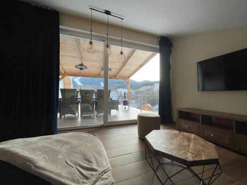 a living room with a view of a dining room at Totina Apartments in Závažná Poruba