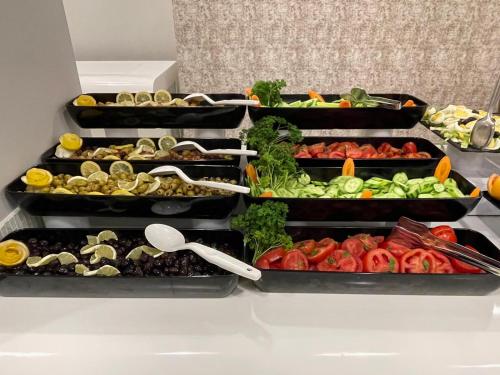 a bunch of trays filled with different types of vegetables at Riviera Zen Hotel Adult Only in Alanya